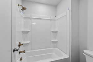 Full bath with toilet and bathtub / shower combination