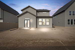Back of property featuring stucco siding and a patio area