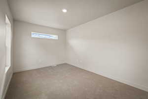 Loft light colored carpet and baseboards