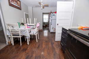 Dining space with dark wood-style floors and a ceiling fan
