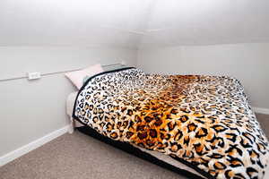 Bedroom featuring carpet floors and baseboards