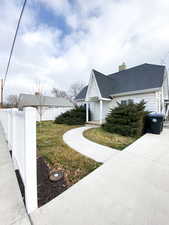 View of home's exterior featuring a chimney and roof with shingles