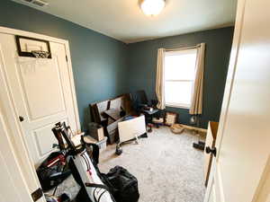 Interior space with light colored carpet and baseboards