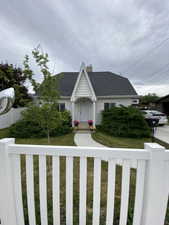 Gabled architectural facade with a prominent white A-frame entryway
