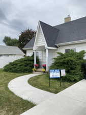 Gable-style home with a dark shingle roof and white siding