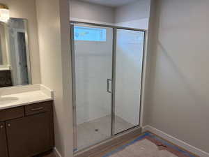 Bathroom featuring vanity and a stall shower