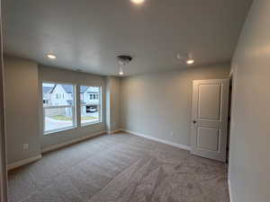 Spare room with recessed lighting and light carpet