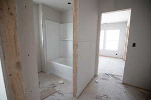 Full bathroom featuring a tub to relax in