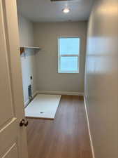 Laundry area featuring hookup for an electric dryer and dark wood finished floors