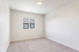 Empty room with baseboards and light carpet