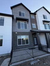 View of front of home with board and batten siding and brick siding