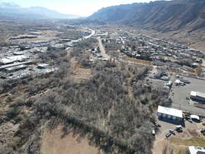 Aerial view of property and surrounding area featuring a mountain backdrop