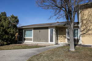 View of exterior entry with a yard