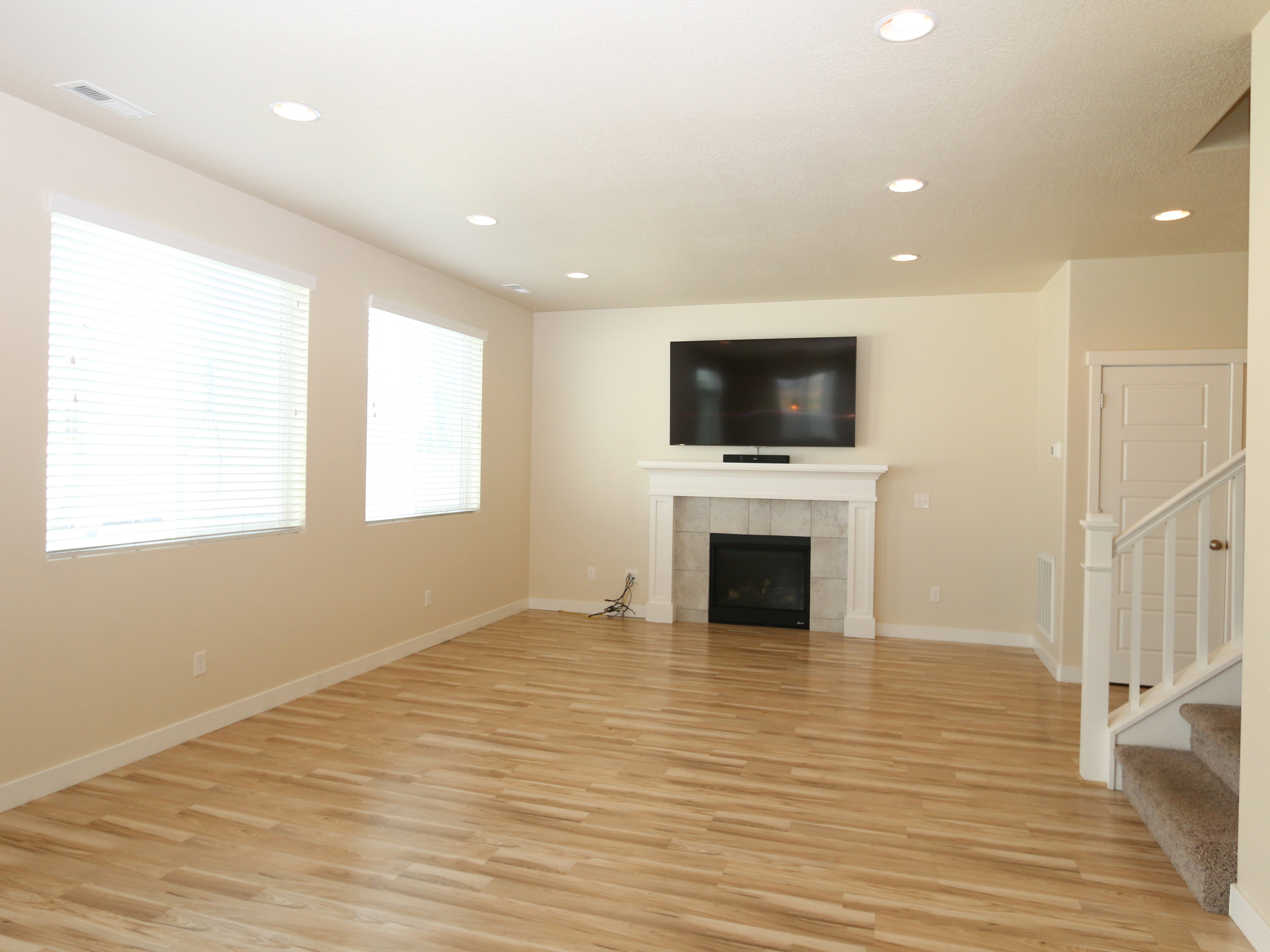 Unfurnished living room with a fireplace, light wood-type flooring, and recessed lighting
