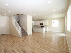 Unfurnished living room featuring light wood finished floors and recessed lighting