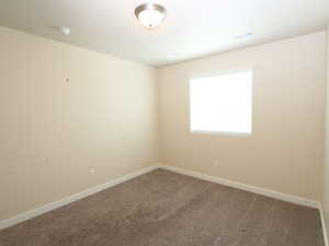 Empty room with carpet floors and baseboards
