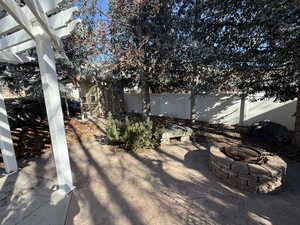 Fenced backyard with a fire pit