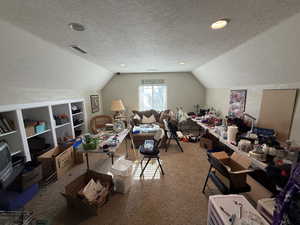 Carpeted office space featuring a textured ceiling