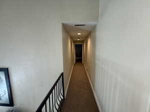 Corridor featuring recessed lighting and carpet