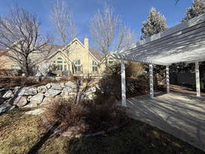 Exterior space featuring a pergola, a chimney, and a patio area