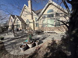 View of home's exterior featuring a patio area, a chimney, and outdoor dining area