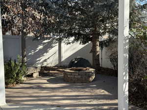 Fenced backyard featuring an outdoor fire pit