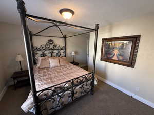 Bedroom with carpet floors and a textured ceiling