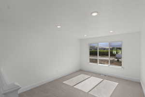 Empty room featuring carpet and recessed lighting