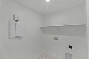 Laundry area featuring hookup for a washing machine, hookup for an electric dryer, and light marble finish floors