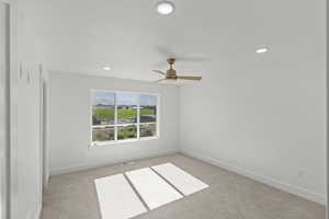 Carpeted empty room featuring recessed lighting and a ceiling fan