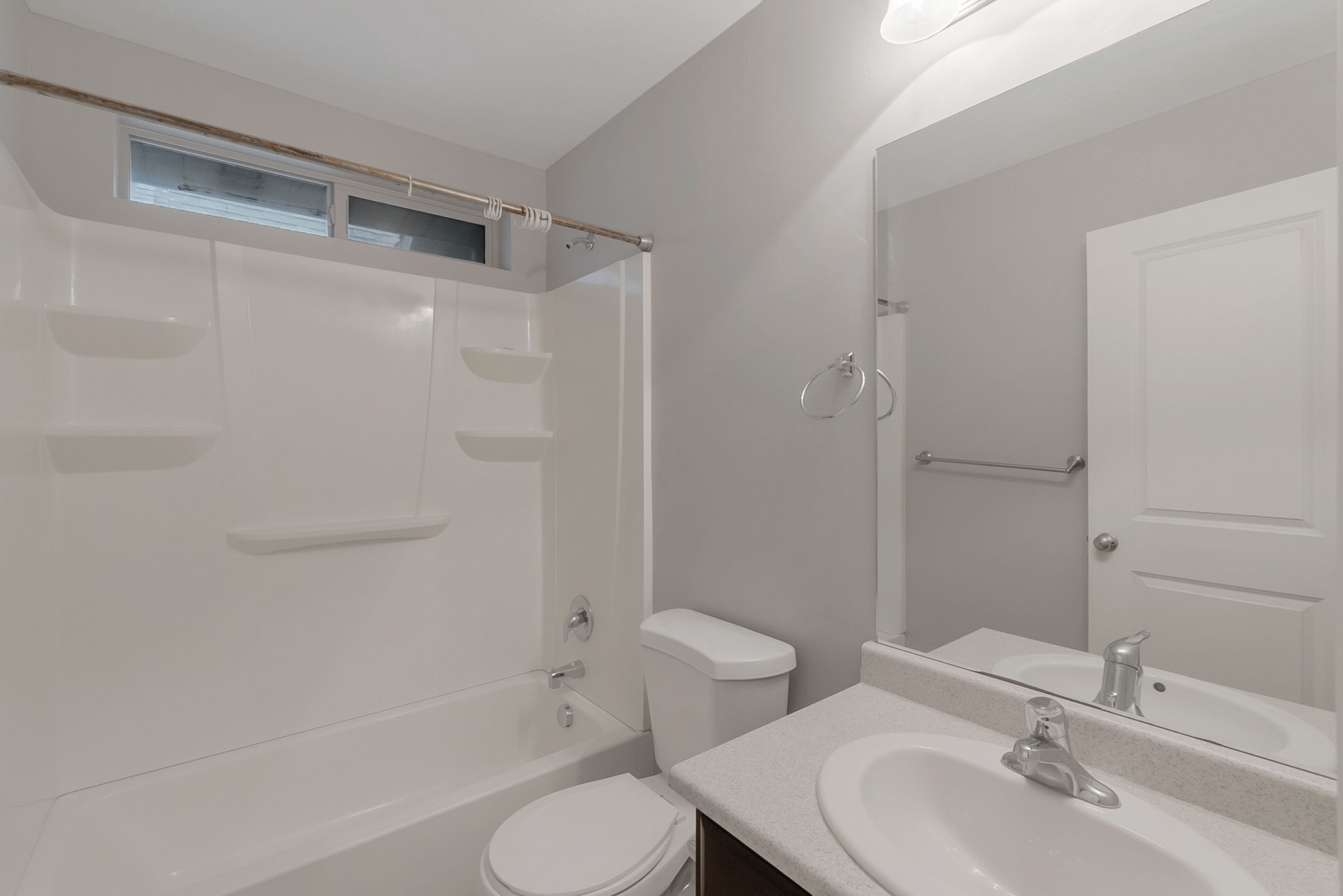 Full bath featuring vanity and washtub / shower combination