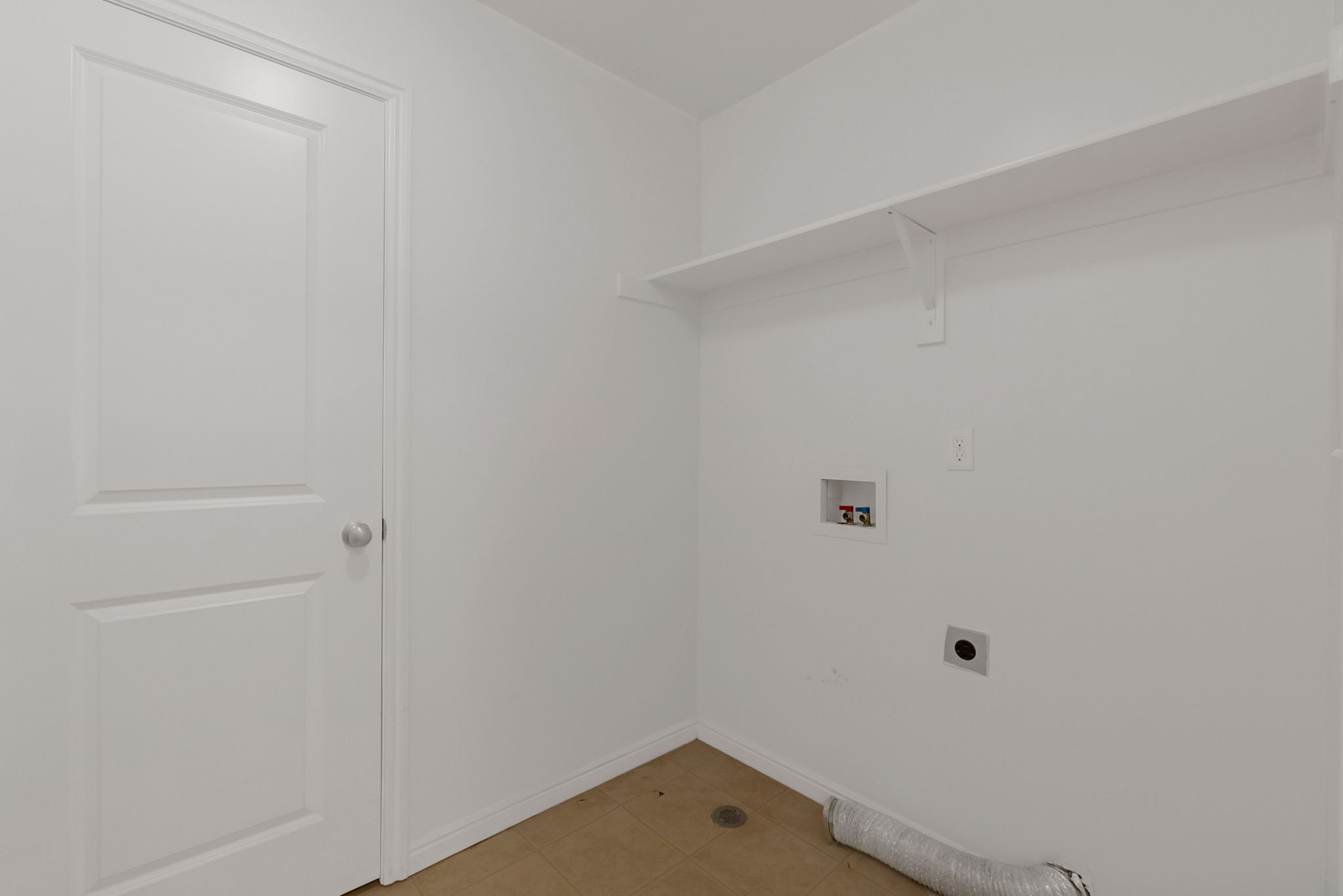 Laundry room with washer hookup, light tile patterned flooring, and hookup for an electric dryer