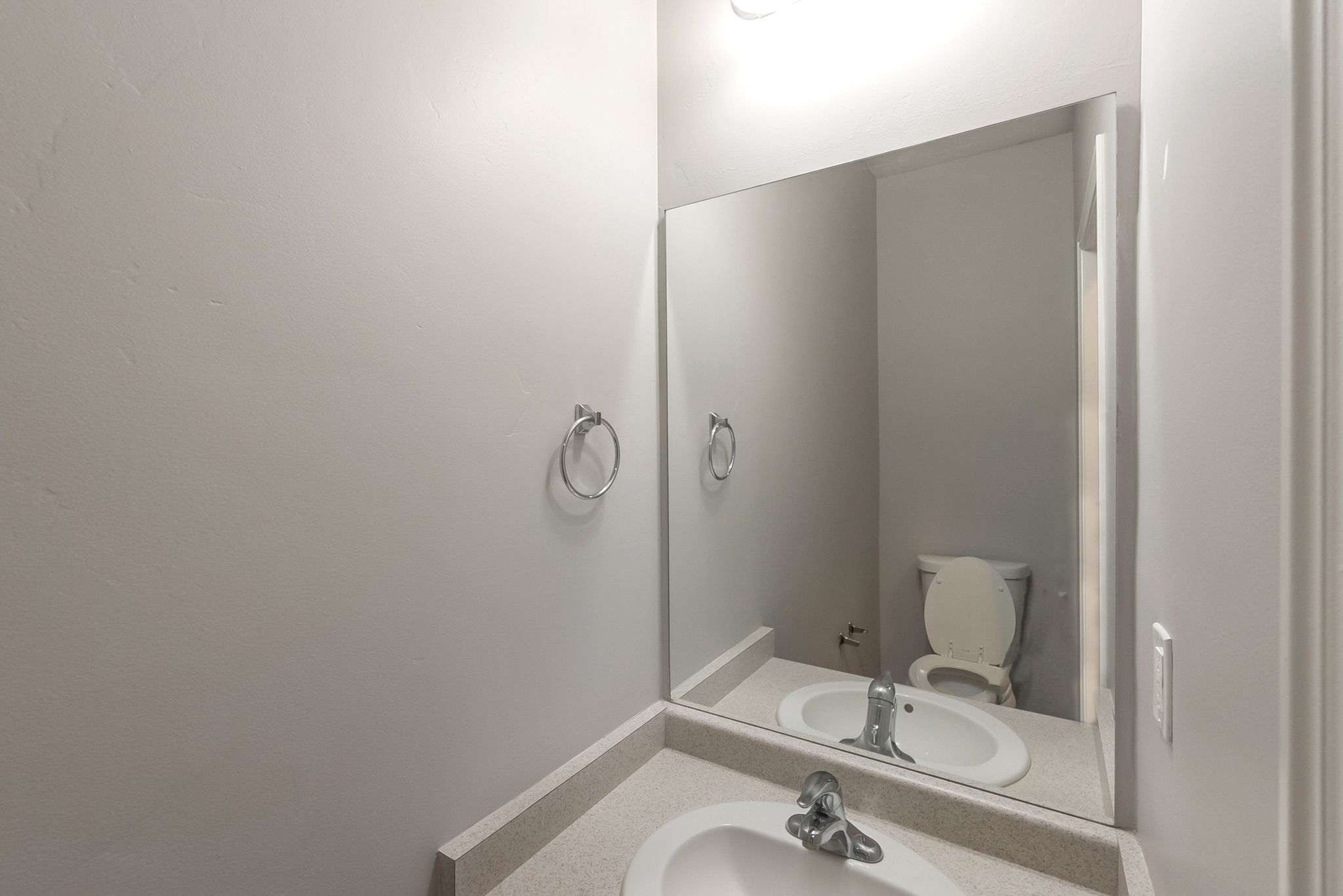 Half bathroom featuring vanity and toilet