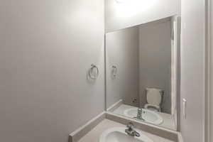 Half bathroom featuring vanity and toilet