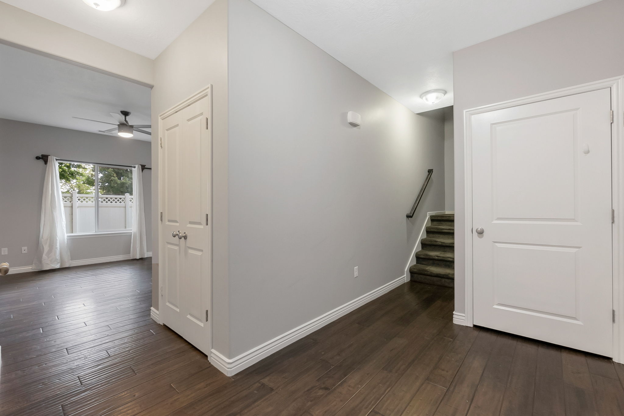 Stairway featuring wood-type flooring and ceiling fan