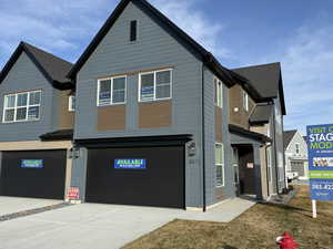 View of front of home with a garage and concrete driveway