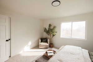 Carpeted bedroom featuring baseboards