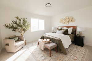Bedroom featuring light carpet and baseboards