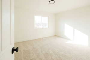 Unfurnished room with carpet and baseboards