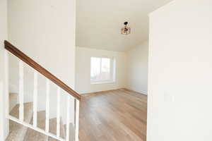 Staircase featuring wood finished floors and baseboards