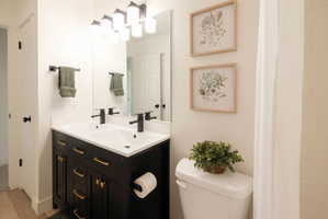 Full bathroom with double vanity and curtained shower