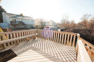 Deck with a storage unit and a residential view