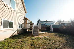 Fenced yard with a wooden deck and a shed