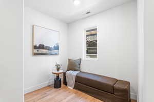 Sitting room featuring light wood-style flooring and baseboards