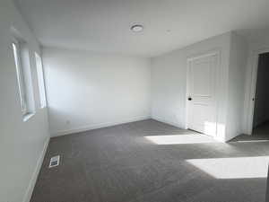 Unfurnished room with carpet floors and baseboards