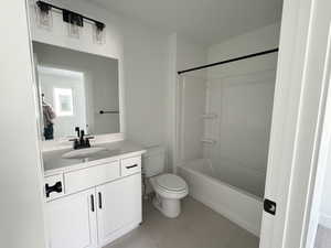 Bathroom featuring vanity, shower / tub combination, and light tile patterned floors