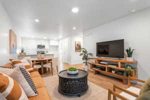 Living room featuring recessed lighting and light wood-style flooring
