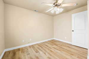 Empty room with light wood-style floors and a ceiling fan