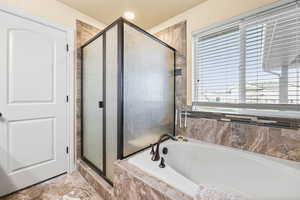 Full bath with a stall shower and a bath