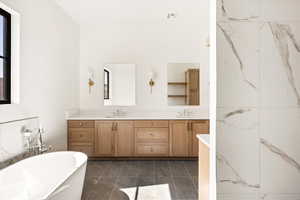 Bathroom featuring a freestanding bath and double vanity